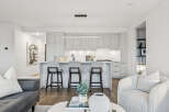 Experience modern living in this stunning kitchen! Featuring sleek cabinetry, a stylish breakfast bar, and high-end appliances, this space is perfect for both cooking and entertaining.
