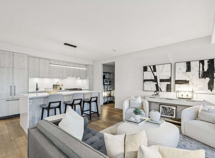 Experience modern luxury in this stunning condo, featuring a sleek kitchen with a breakfast bar and high-end appliances.