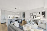 Experience modern luxury in this stunning condo, featuring a sleek kitchen with a breakfast bar and high-end appliances.