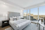 Experience luxury living in this stunning bedroom with breathtaking city views.