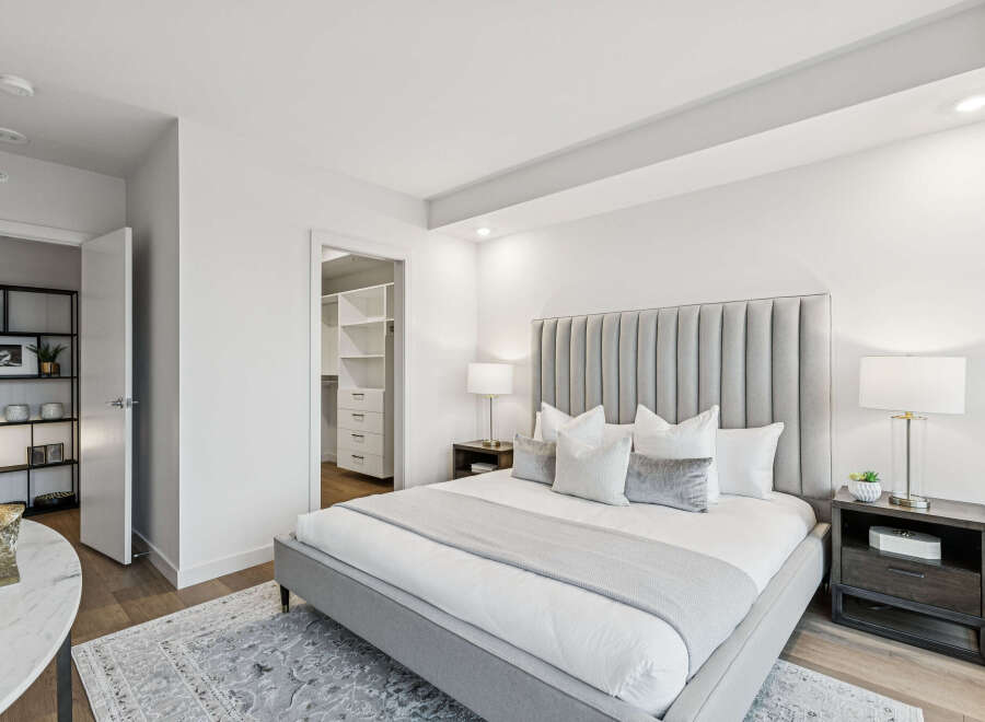 Step into luxury with this stunning bedroom featuring a plush, upholstered headboard and a cozy, inviting bed.