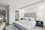 Step into luxury with this stunning bedroom featuring a plush, upholstered headboard and a cozy, inviting bed.