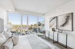 Experience luxury living in this stunning bedroom with breathtaking city views.