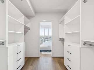 Step into luxury with this stunning walk-in closet, offering ample storage and organization.
