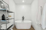 Step into a serene bathroom oasis, featuring a luxurious soaking tub and modern fixtures.