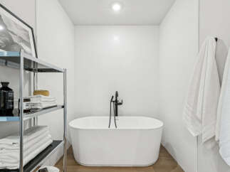 Step into a serene bathroom oasis, featuring a luxurious soaking tub and modern fixtures.