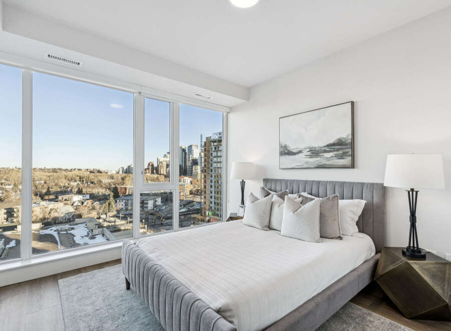 Experience luxury living in this stunning bedroom with breathtaking city views.