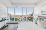 Experience luxury living in this stunning bedroom with breathtaking city views.