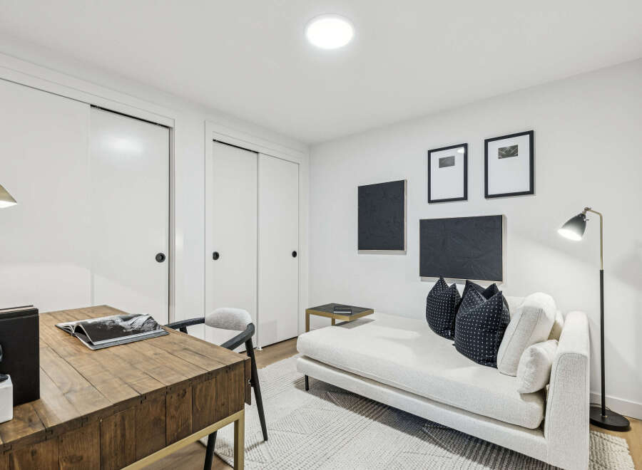 This stylish room features a modern design with a comfortable chaise lounge and decorative pillows, perfect for relaxation.