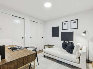 This stylish room features a modern design with a comfortable chaise lounge and decorative pillows, perfect for relaxation.