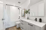 Step into a modern bathroom oasis! This stunning space features sleek, contemporary design elements, including a stylish vanity with ample storage.
