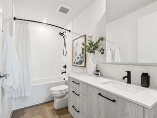 Step into a modern bathroom oasis! This stunning space features sleek, contemporary design elements, including a stylish vanity with ample storage.