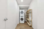 This modern laundry room features a stacked Whirlpool washer and dryer, maximizing space and efficiency.