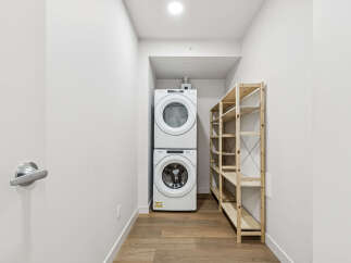 This modern laundry room features a stacked Whirlpool washer and dryer, maximizing space and efficiency.