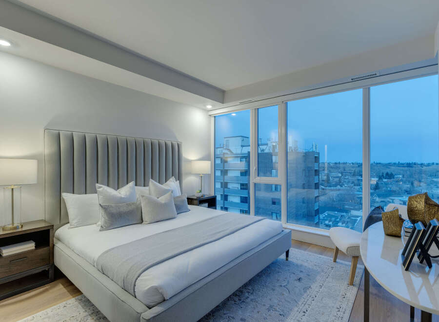 Experience luxury in this stunning bedroom with breathtaking city views.