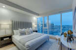 Experience luxury in this stunning bedroom with breathtaking city views.