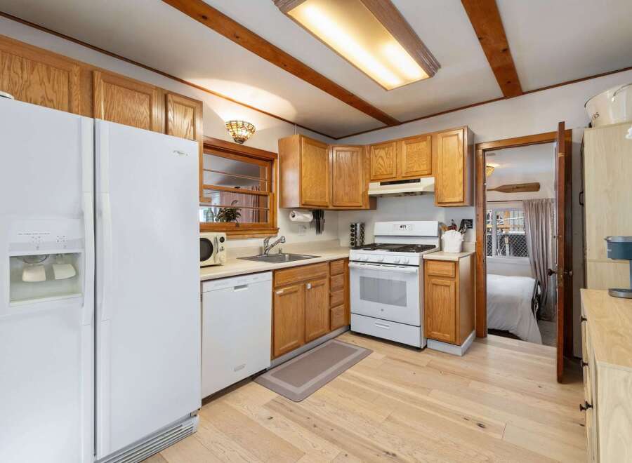 Step into this charming kitchen, featuring warm wooden cabinetry and a bright, inviting atmosphere.