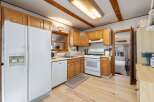 Step into this charming kitchen, featuring warm wooden cabinetry and a bright, inviting atmosphere.