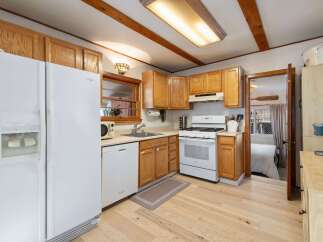 Step into this charming kitchen, featuring warm wooden cabinetry and a bright, inviting atmosphere.