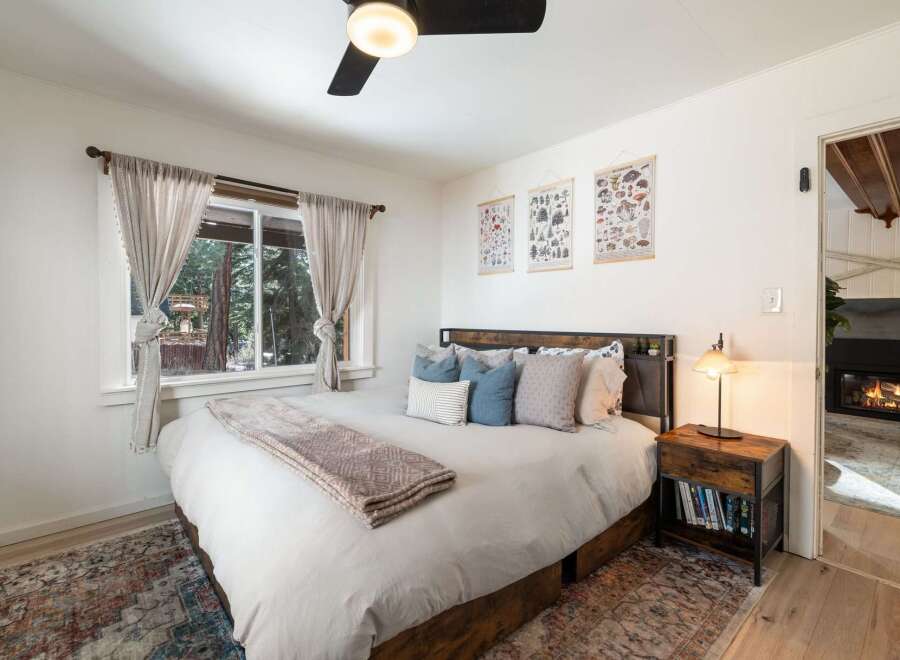 This cozy bedroom features a comfortable bed with soft bedding and decorative pillows, perfect for a relaxing retreat.
