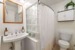 Step into this charming bathroom featuring a unique glass block shower enclosure.