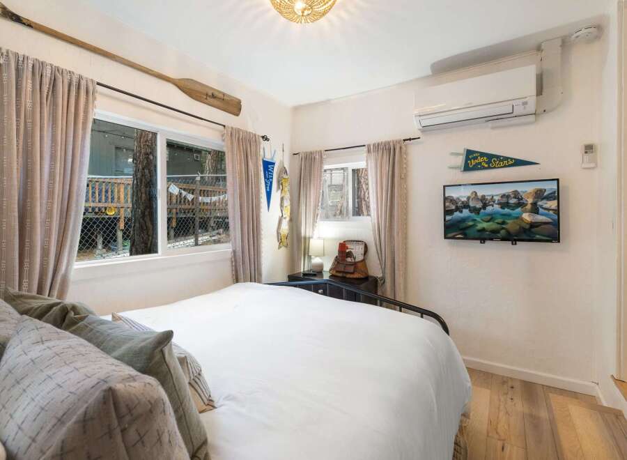 This charming bedroom offers a cozy retreat with its inviting ambiance and rustic decor.