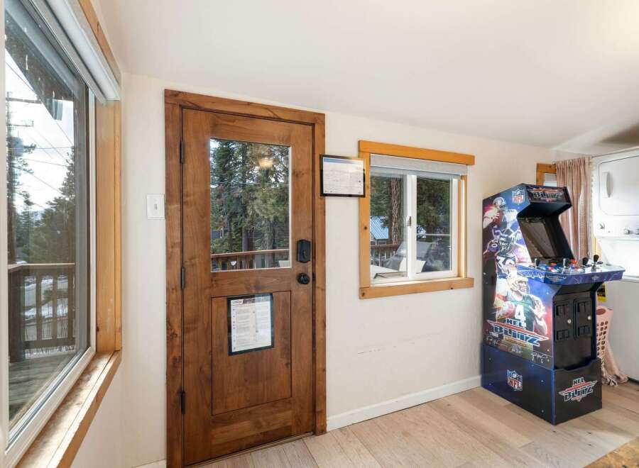 Step into this inviting space, featuring a charming wooden door and a window that frames picturesque views.