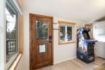 Step into this inviting space, featuring a charming wooden door and a window that frames picturesque views.