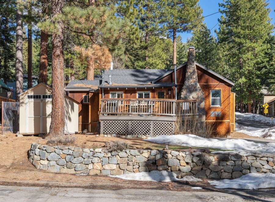 Nestled amidst towering trees, this charming cabin offers a serene retreat.