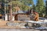 Nestled amidst towering trees, this charming cabin offers a serene retreat.