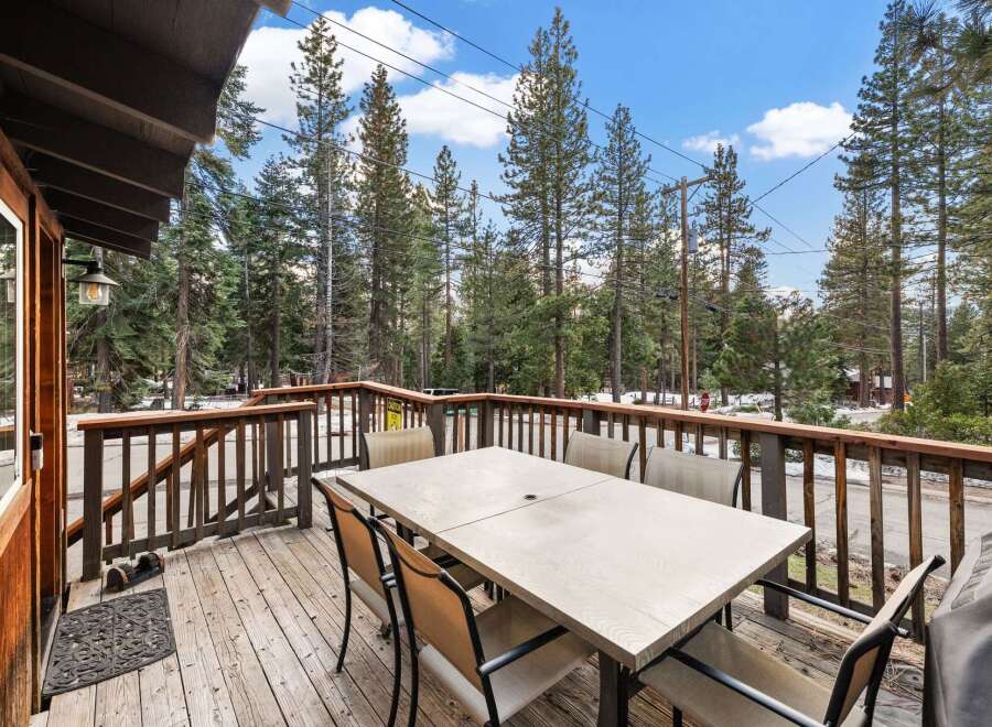 Enjoy the tranquility of this stunning property with a spacious deck perfect for outdoor dining and relaxation.