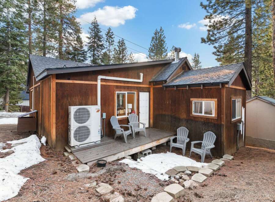 Nestled amidst towering trees, this charming cabin offers a serene escape.