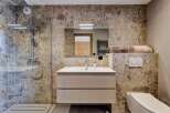 This stunning bathroom features a modern design with a sleek vanity and a spacious shower.