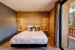 This cozy bedroom features a stunning wooden accent wall, creating a warm and inviting atmosphere.