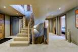 Step into luxury with this stunning property featuring a grand staircase and modern design.