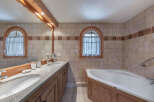 This stunning bathroom features a luxurious design with a double vanity and a relaxing bathtub.