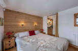 This cozy bedroom features a stunning wooden accent wall, creating a warm and inviting atmosphere.
