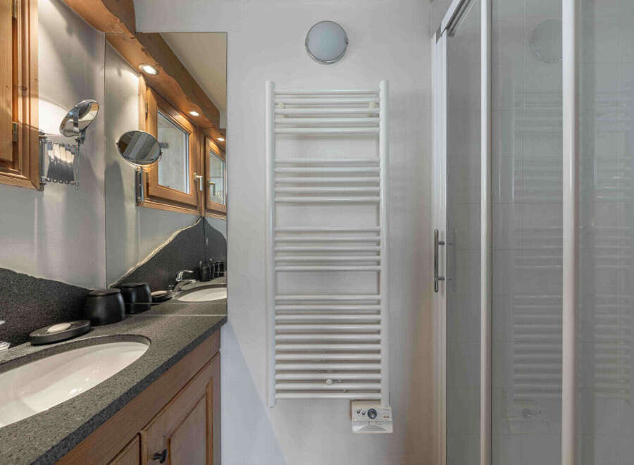 This stunning bathroom boasts a modern design with a touch of rustic charm.