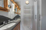 Step into luxury with this stunning bathroom featuring a sleek design and modern amenities.