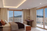 Experience luxury living with this stunning bedroom featuring breathtaking mountain views.