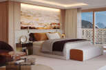 Experience luxury living in this stunning bedroom with breathtaking mountain views.