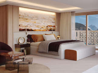 Experience luxury living in this stunning bedroom with breathtaking mountain views.