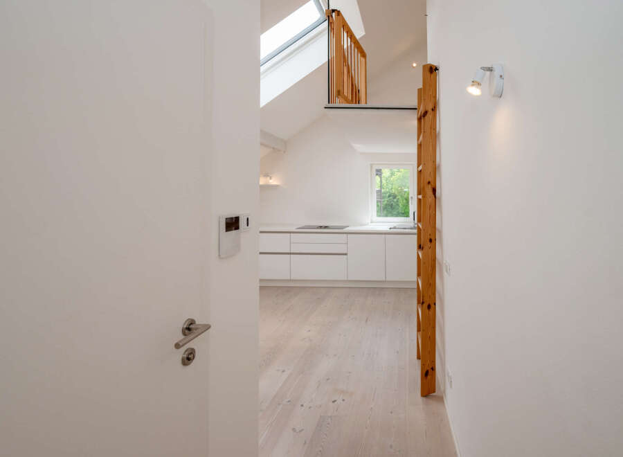 Discover this stunning property featuring a modern kitchen with sleek white cabinetry and a bright, airy atmosphere.