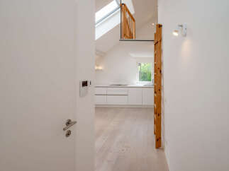 Discover this stunning property featuring a modern kitchen with sleek white cabinetry and a bright, airy atmosphere.