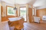 Experience rustic charm in this inviting dining area, featuring a solid wood table and benches perfect for family gatherings.