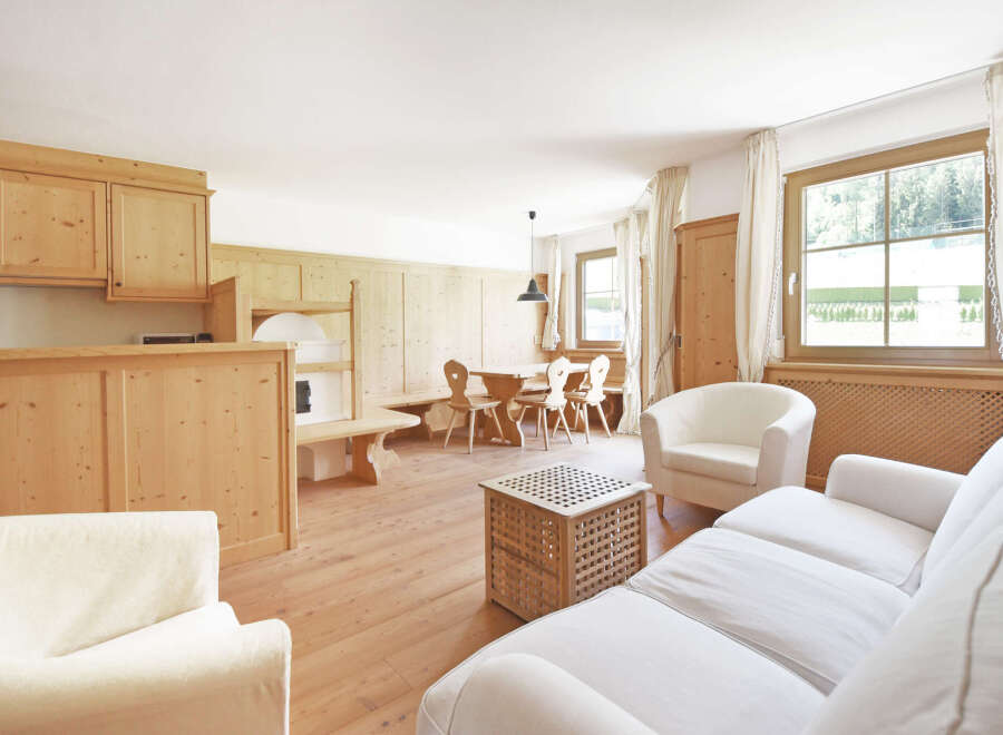 Experience rustic charm in this inviting living space, featuring warm wooden cabinetry and paneling that creates a cozy ambiance.