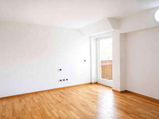 Step into this bright and airy room, featuring a beautiful hardwood floor that gleams under natural light.