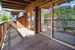 Experience the charm of this wooden balcony, offering a serene outdoor space with stunning mountain views.