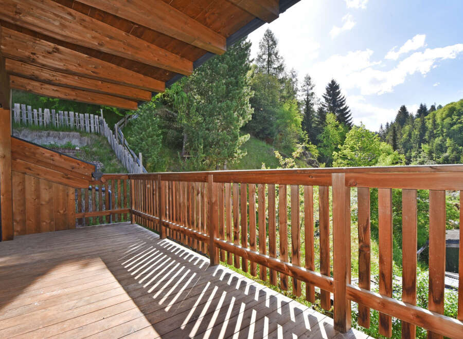 Enjoy the serene mountain views from this charming wooden balcony, perfect for morning coffee or evening relaxation.