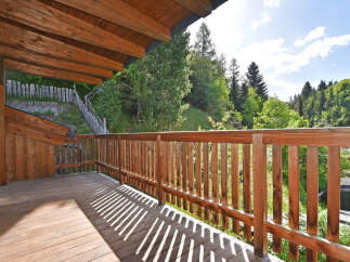 Enjoy the serene mountain views from this charming wooden balcony, perfect for morning coffee or evening relaxation.